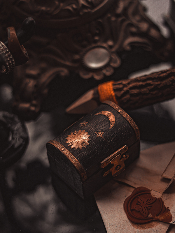 black wooden box with stars and moon on an old wooden table on wooden letters with seals